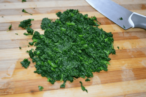 Chop blanched spinach with knife
