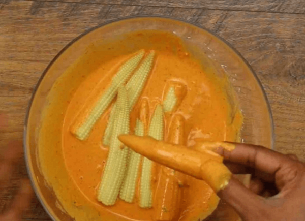 roll baby corns in the batter